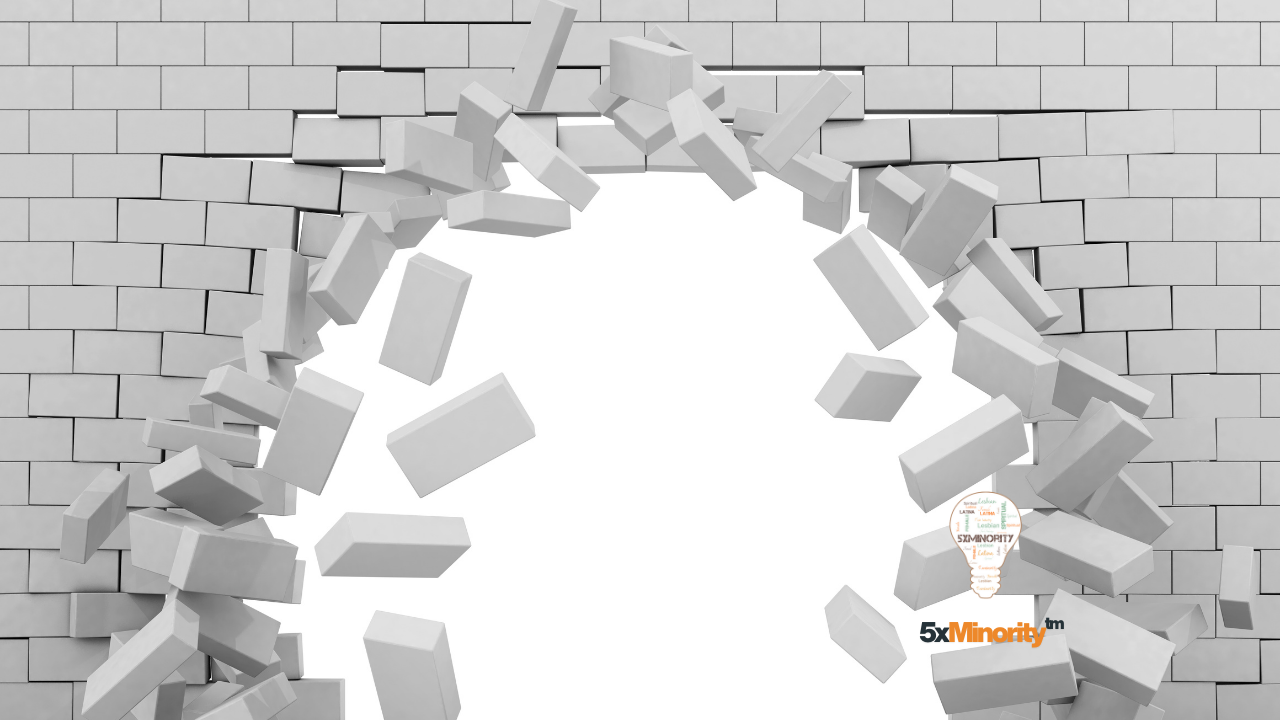 Bricks falling from a wall symbolizing breaking barriers and shattering glass ceilings, representing Hispanic leaders in technology and innovation during Hispanic Heritage Month 2025.